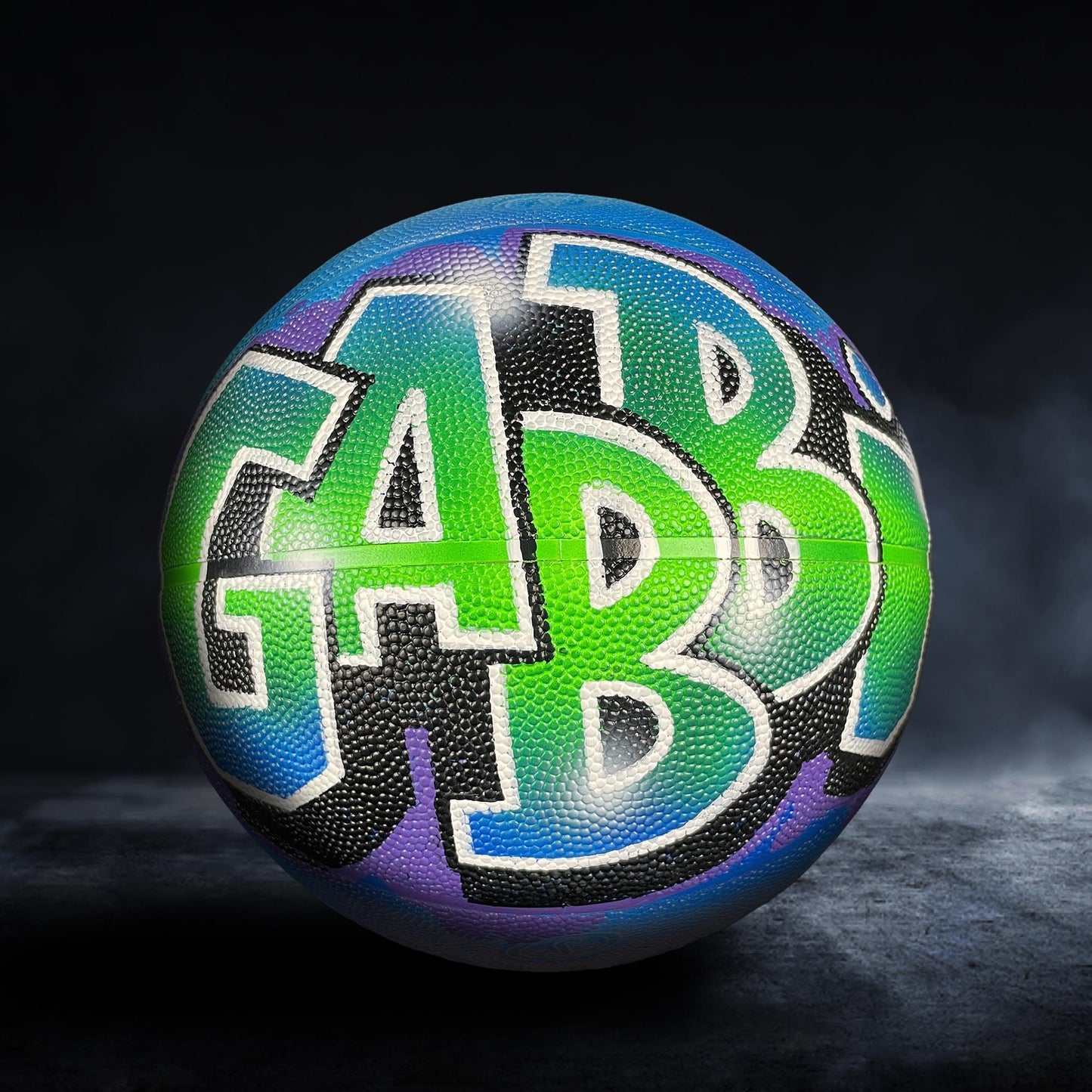A colorful basketball with the word "GAB" painted on it.