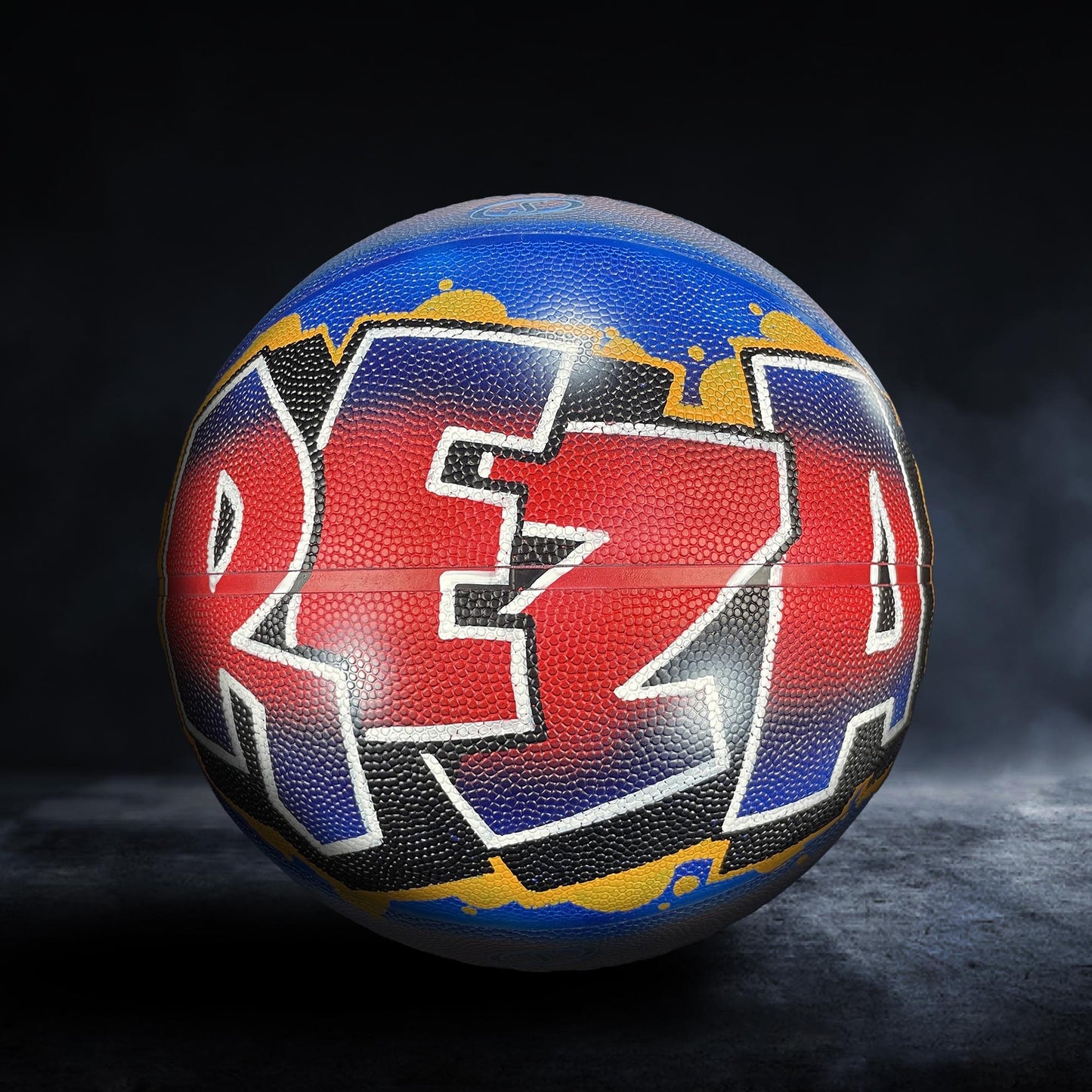A basketball with the word "REZA" painted on it in a colorful, graffiti-style design.