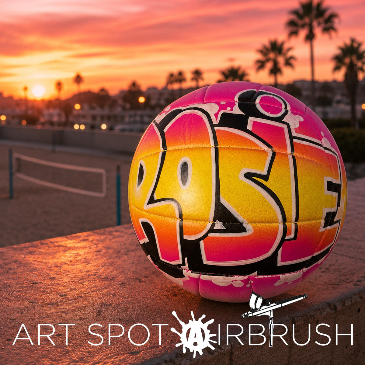 A colorful custom volleyball personalized with the word "ROSIE" painted on it, set against a backdrop of a sunset and palm trees.