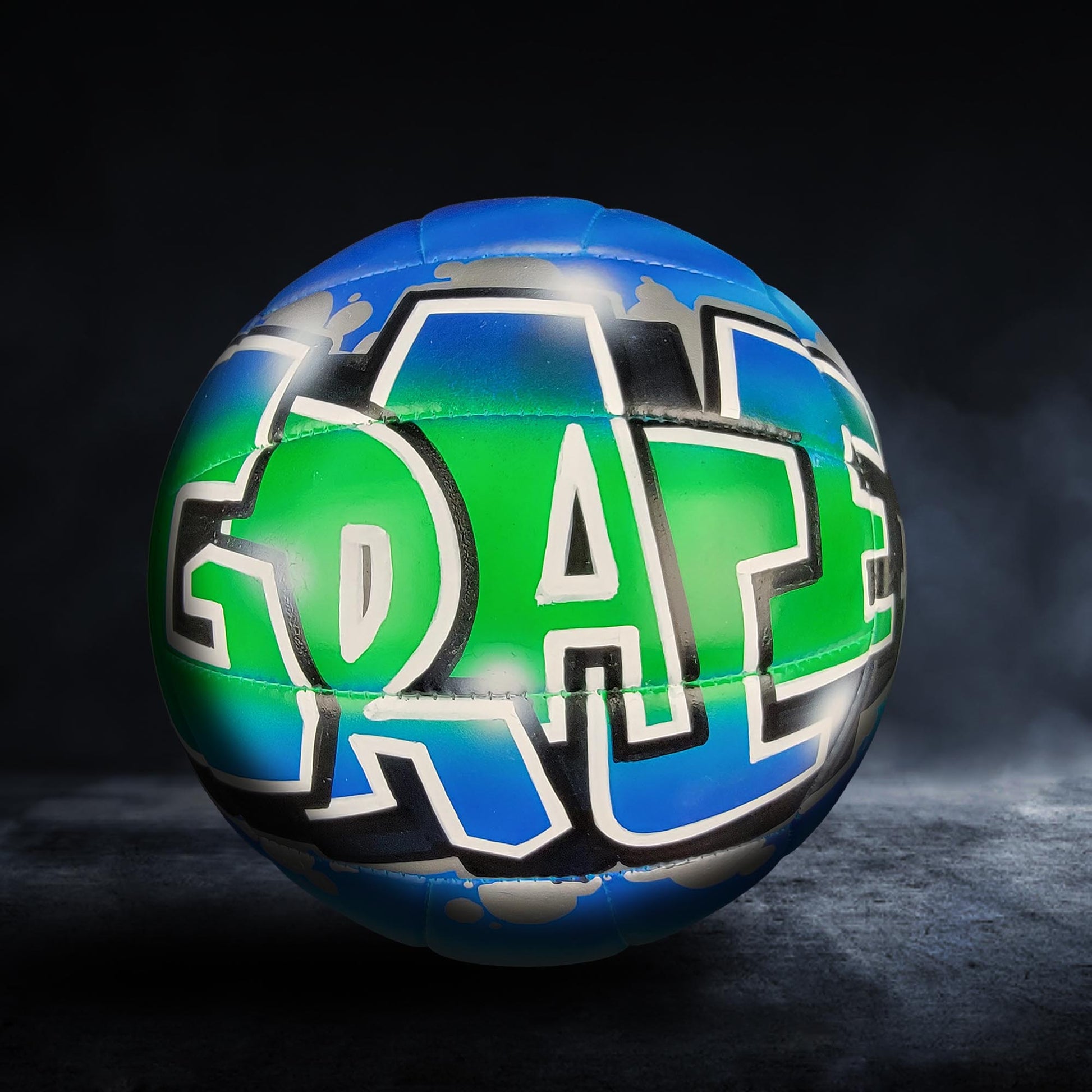 A colorful, graffiti-style volleyball with the word "RAZE" painted on it, set against a dark background.