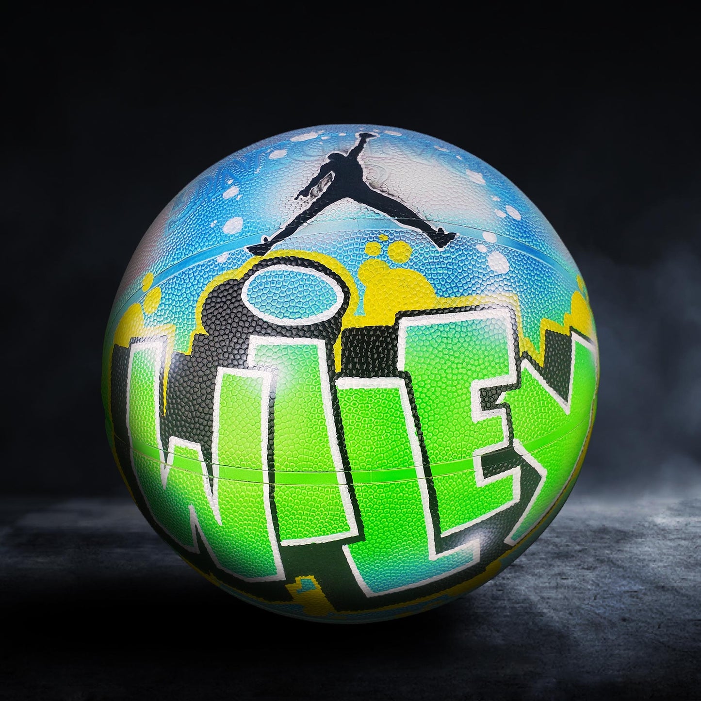 A basketball with a colorful, graffiti-style design on it, featuring the word "WILLEY" prominently displayed.