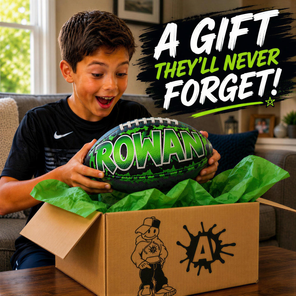 A young boy excitedly opens a gift box containing a green and black football with the name "Rowan" on it.