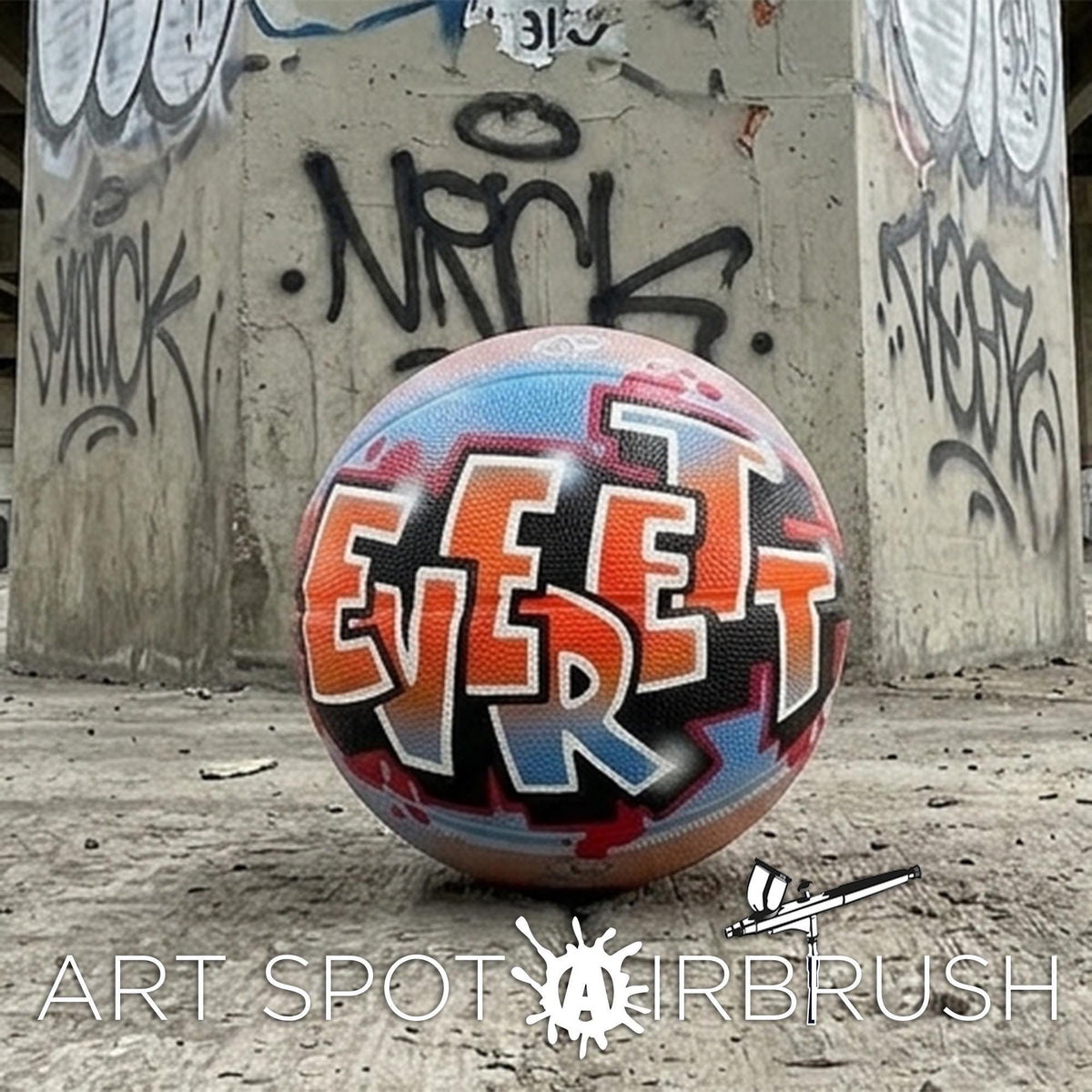 a colorful basketball with graffiti on it, placed in front of a concrete wall with graffiti.