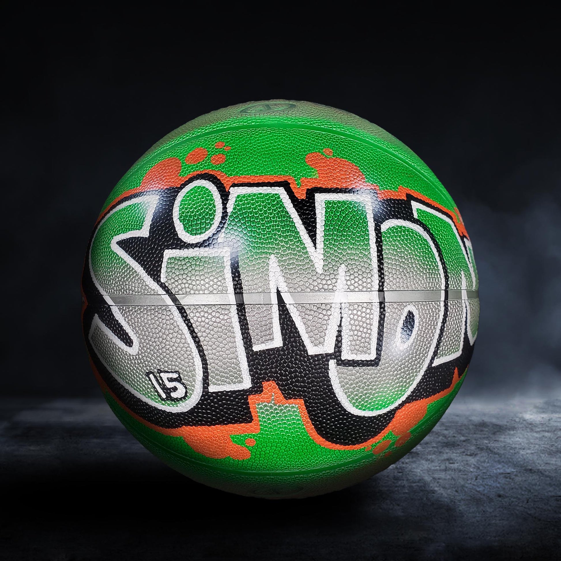 A basketball with the word "SIMO" painted on it in graffiti-style lettering.