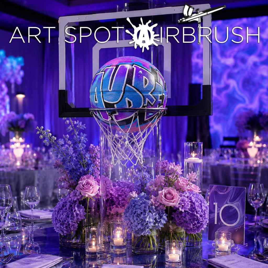 a basketball hoop decorated with purple and blue flowers, surrounded by a table set with candles and place settings, creating a festive atmosphere.