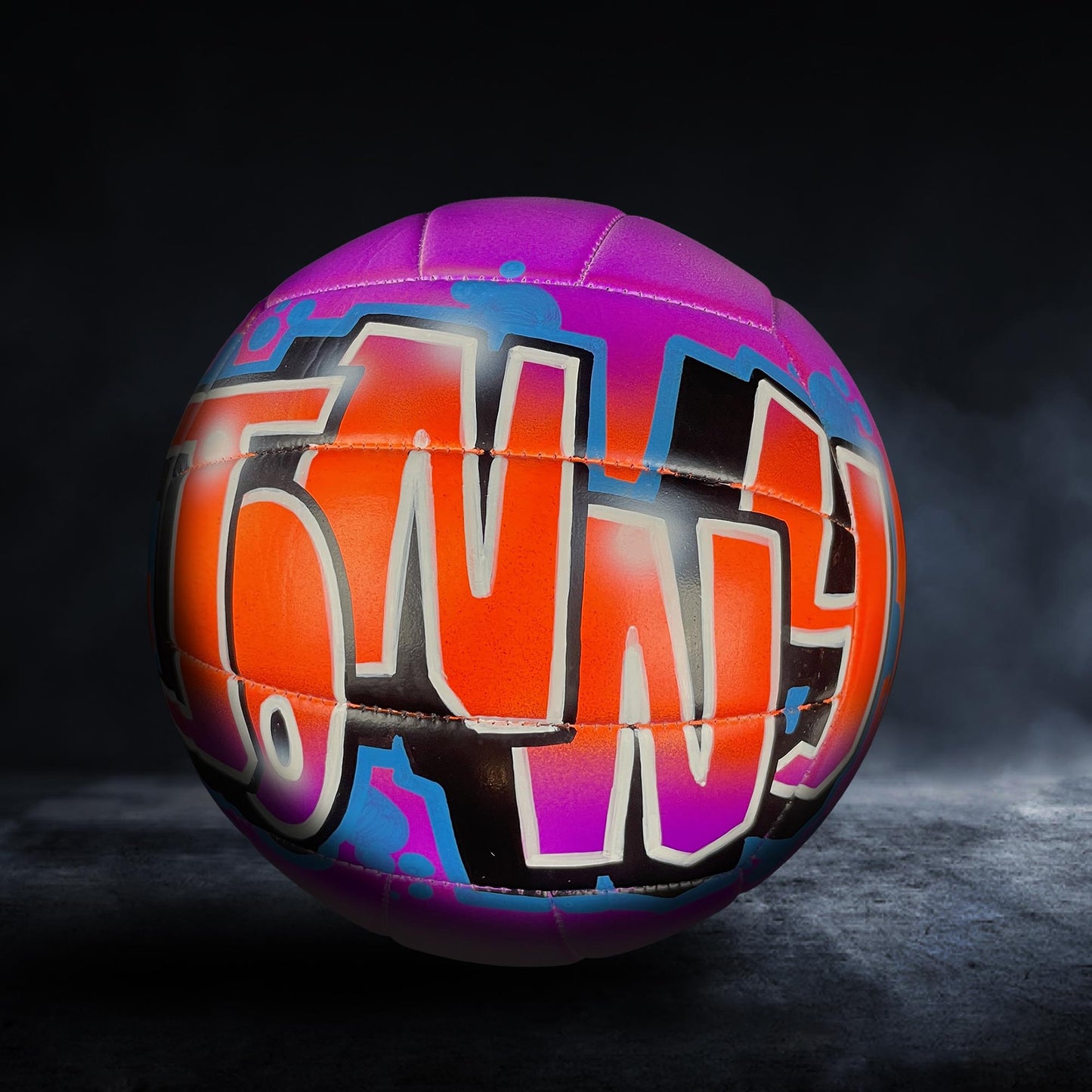 A colorful, graffiti-style soccer ball with the word "TONY" painted on it.