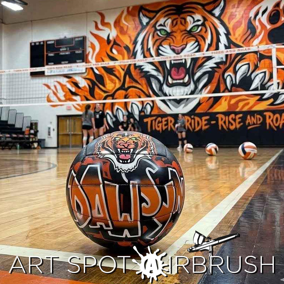 A volleyball court with a large tiger mural on the wall behind it, and a graffiti-style custom volleyball with the word "DAWSYN" written on it in the foreground.