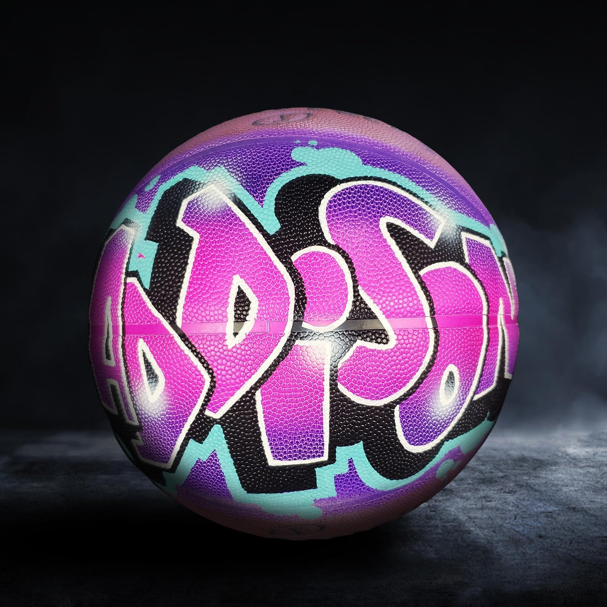 A colorful basketball with the word "HADIS" painted on it in a graffiti-style design.