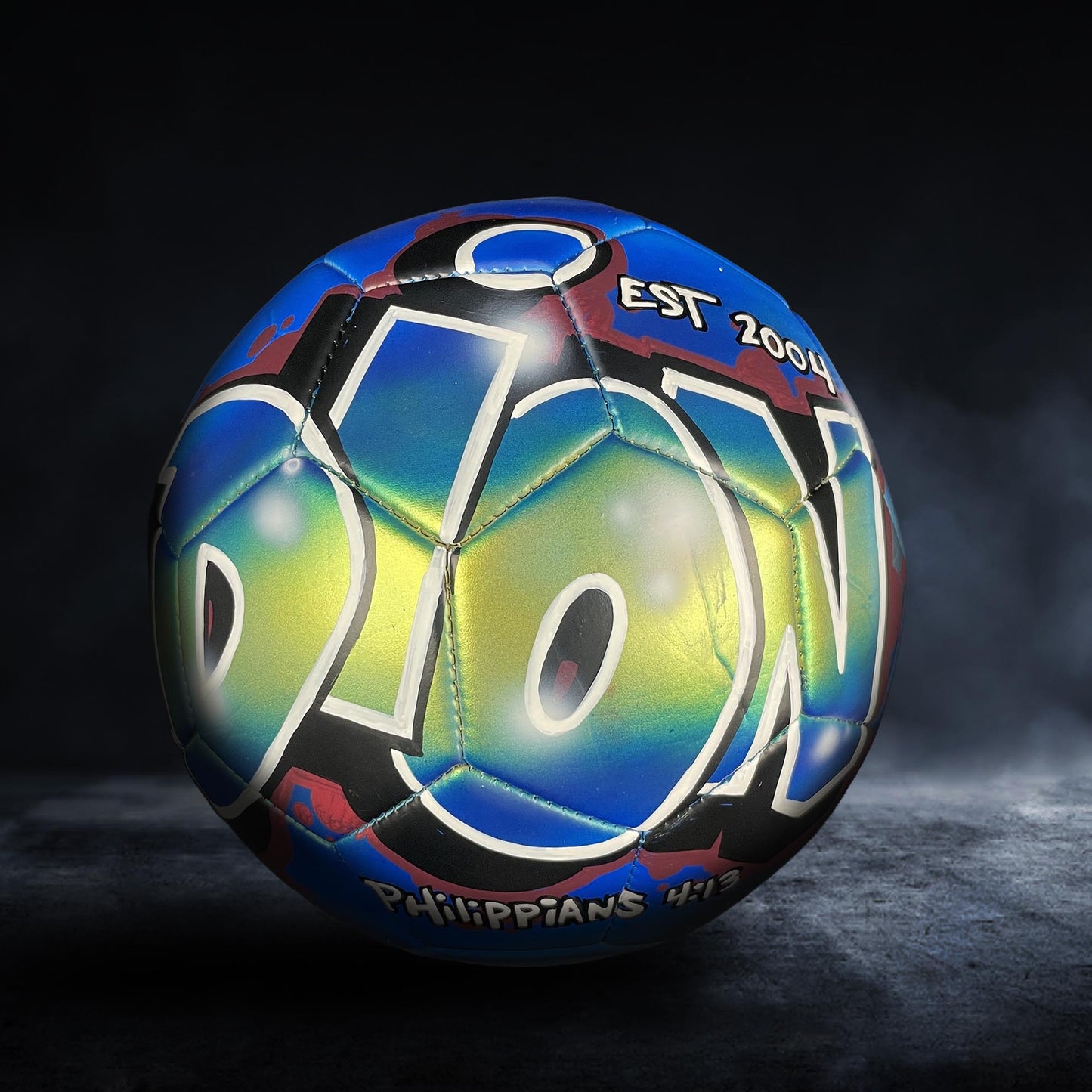 A colorful soccer ball with the word "DION" prominently displayed on it, set against a dark background.