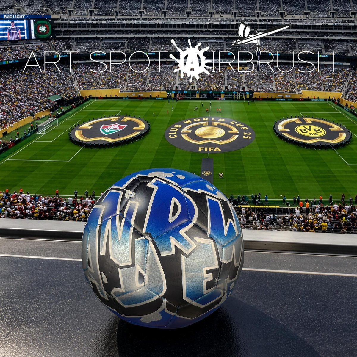 a soccer ball with the word "W" on it, placed on a field in front of a large crowd at a stadium.
