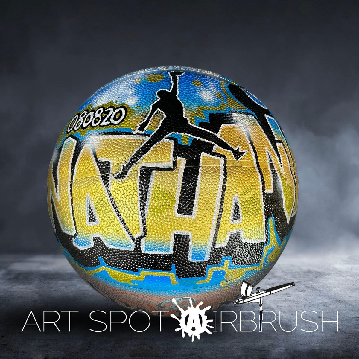 A colorful basketball with the word "NATION" painted on it, featuring a silhouette of a person jumping in the air.