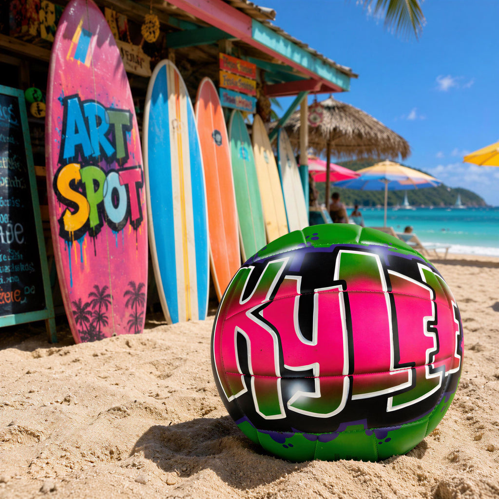 A colorful surfboard with the name " Kyle" painted on it, along with a green and pink sports ball, is placed on a sandy beach in front of a row of colorful surfboards and a thatched-roof hut.