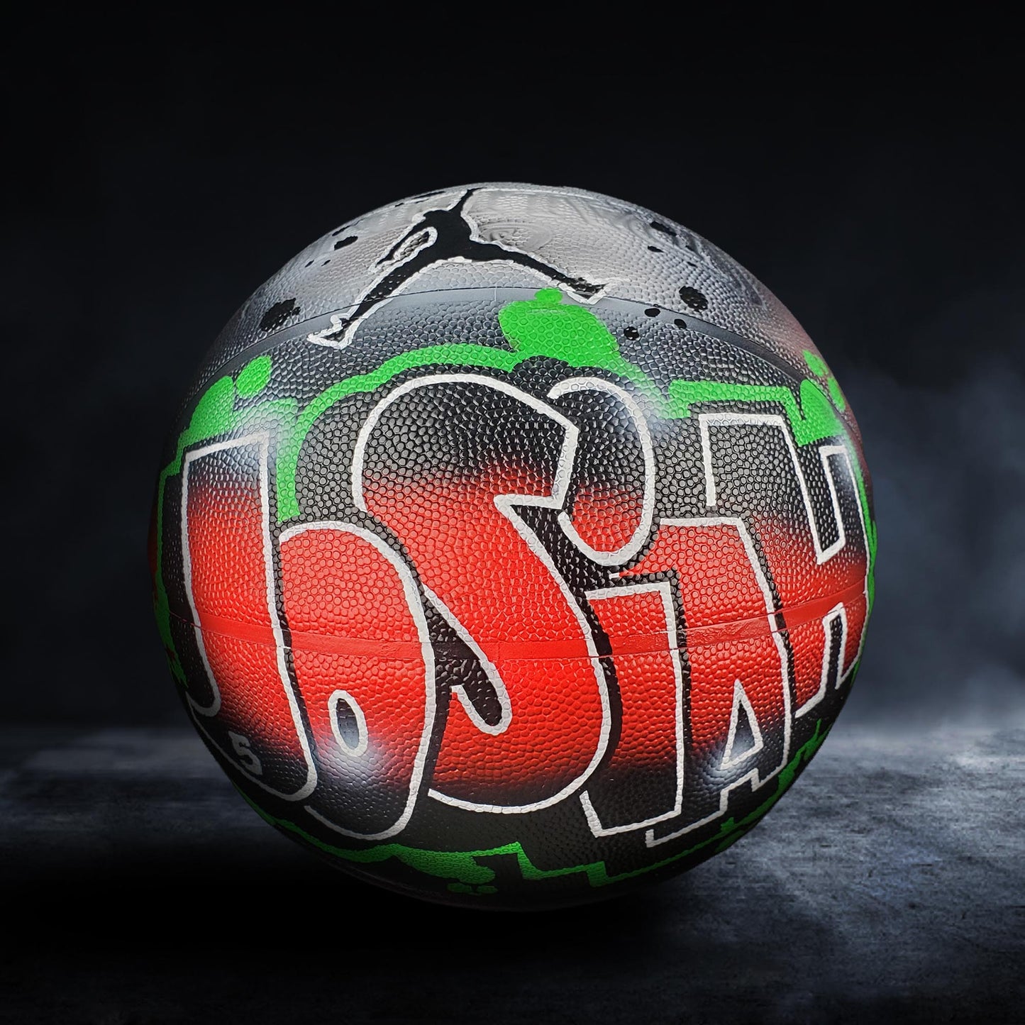 A basketball with the name "Jorden" painted on it in graffiti-style lettering.