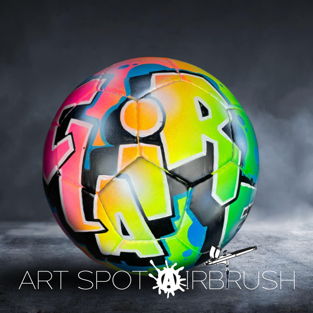 A colorful, graffiti-style soccer ball with the text "ART SPOT AIRBRUSH" displayed on it.