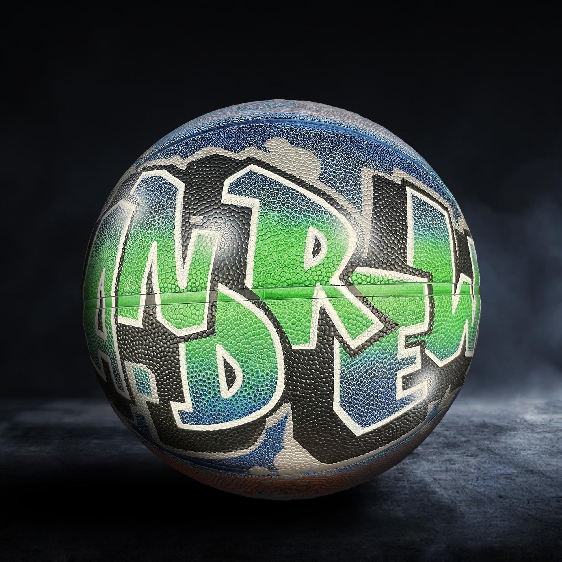 A basketball with the name "Andrew" painted on it in graffiti-style lettering.