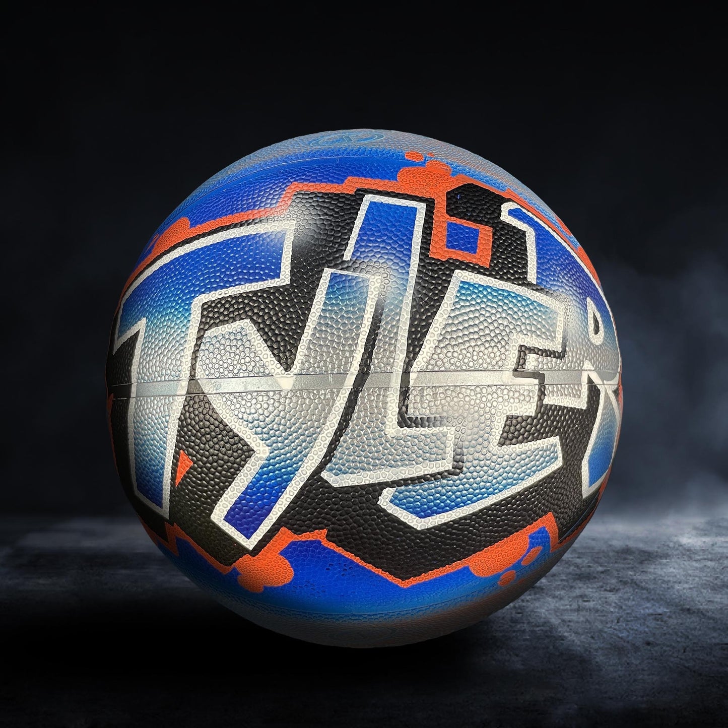 A basketball with the name " Tyler" painted on it in a stylized, graffiti-like design.