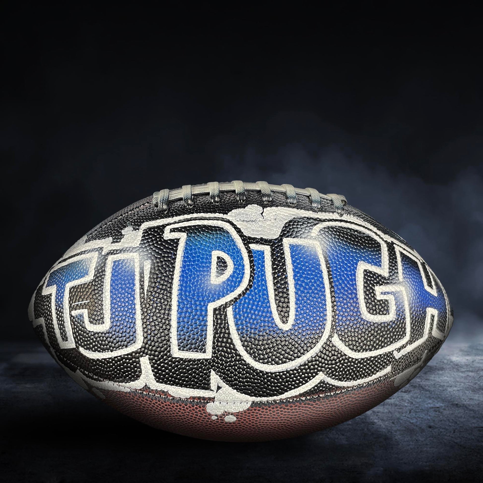 A football with the word "PUCH" written on it in blue and white text.
