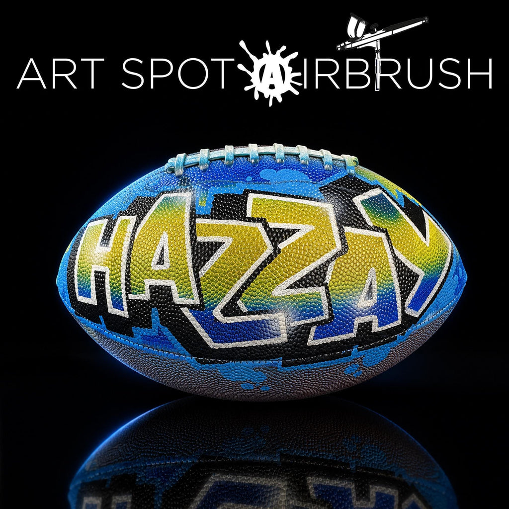 a personalized custom football with the word "HAZZAY" painted on it