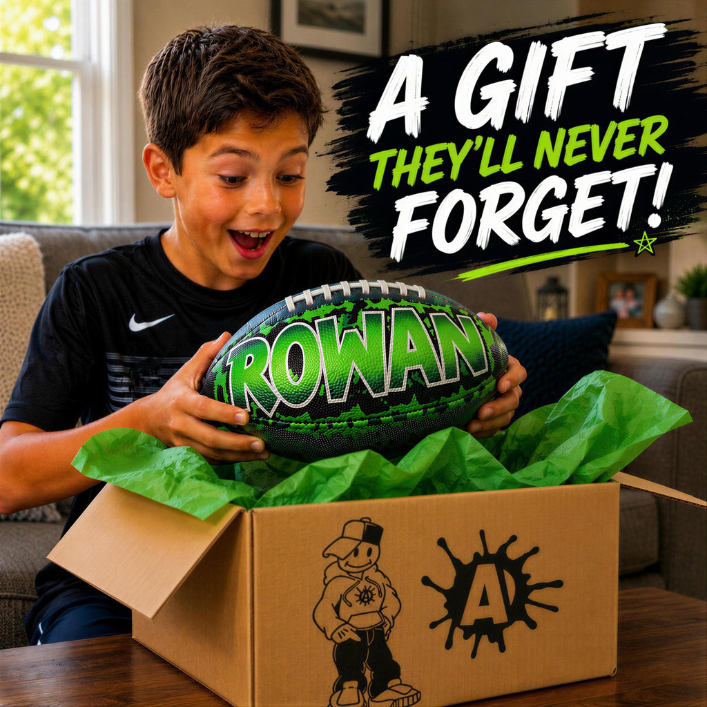 A young boy excitedly opens a gift box containing a green and black custom football personalized with the name "Rowan" on it.