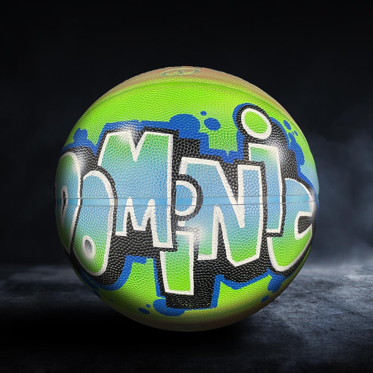 A colorful basketball with graffiti-style lettering on it, set against a dark background.