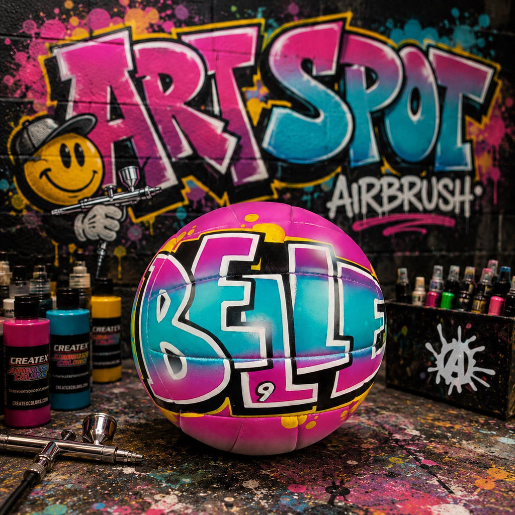 a custom-painted volleyball with the word "Belle" written on it, surrounded by various spray paint cans and a graffiti-style background.