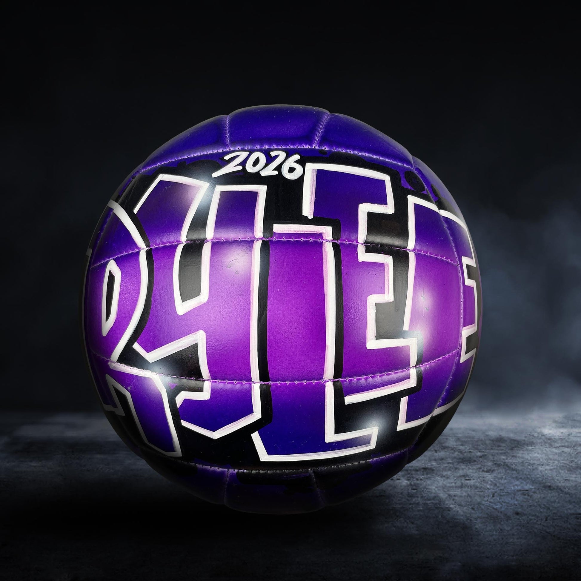 A purple and black soccer ball with the year "2026" printed on it.