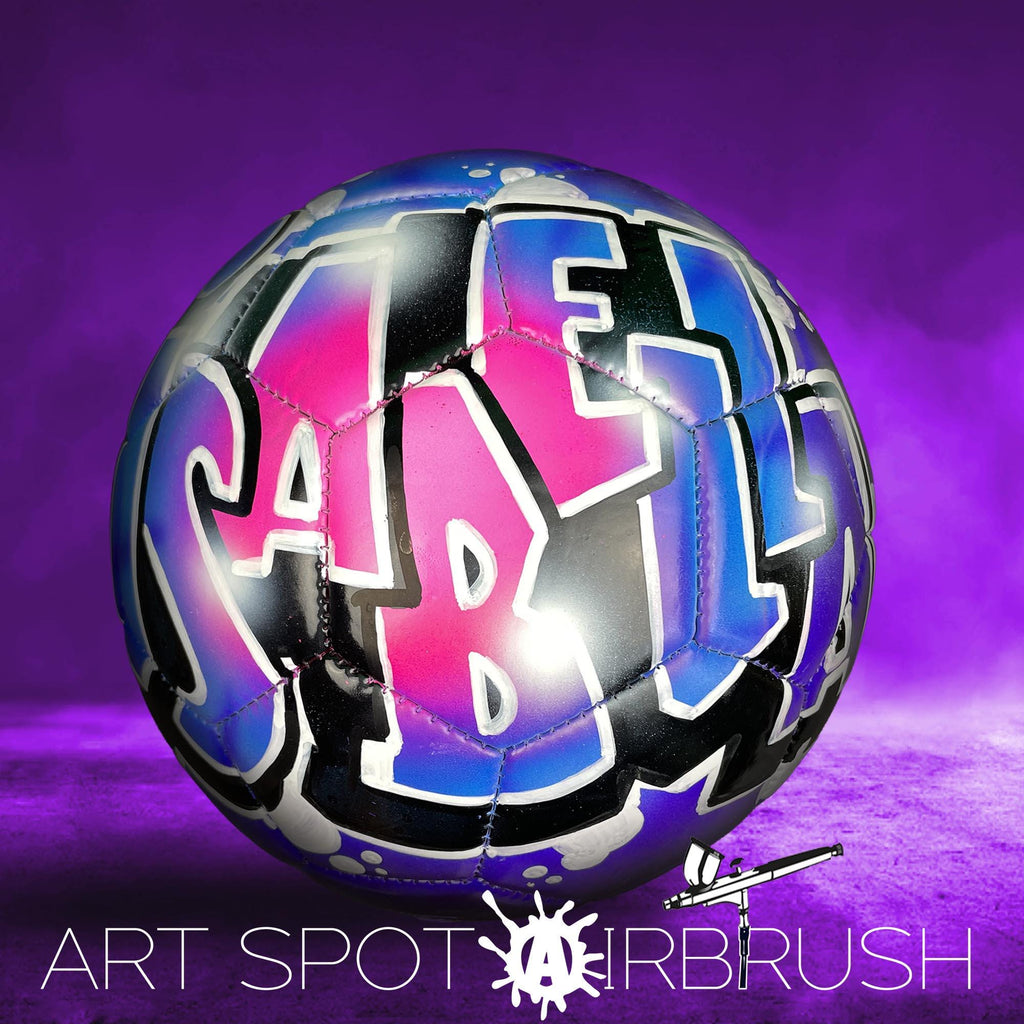 A colorful soccer ball with graffiti-style lettering on it, set against a purple background.