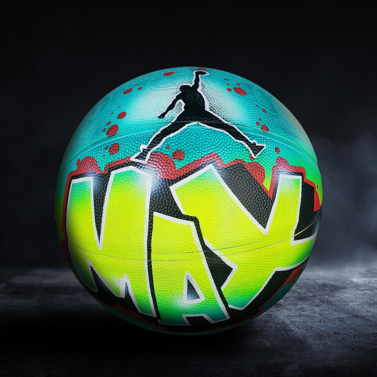 A colorful basketball with the word "MAX" painted on it, featuring a silhouette of a person jumping in the air.