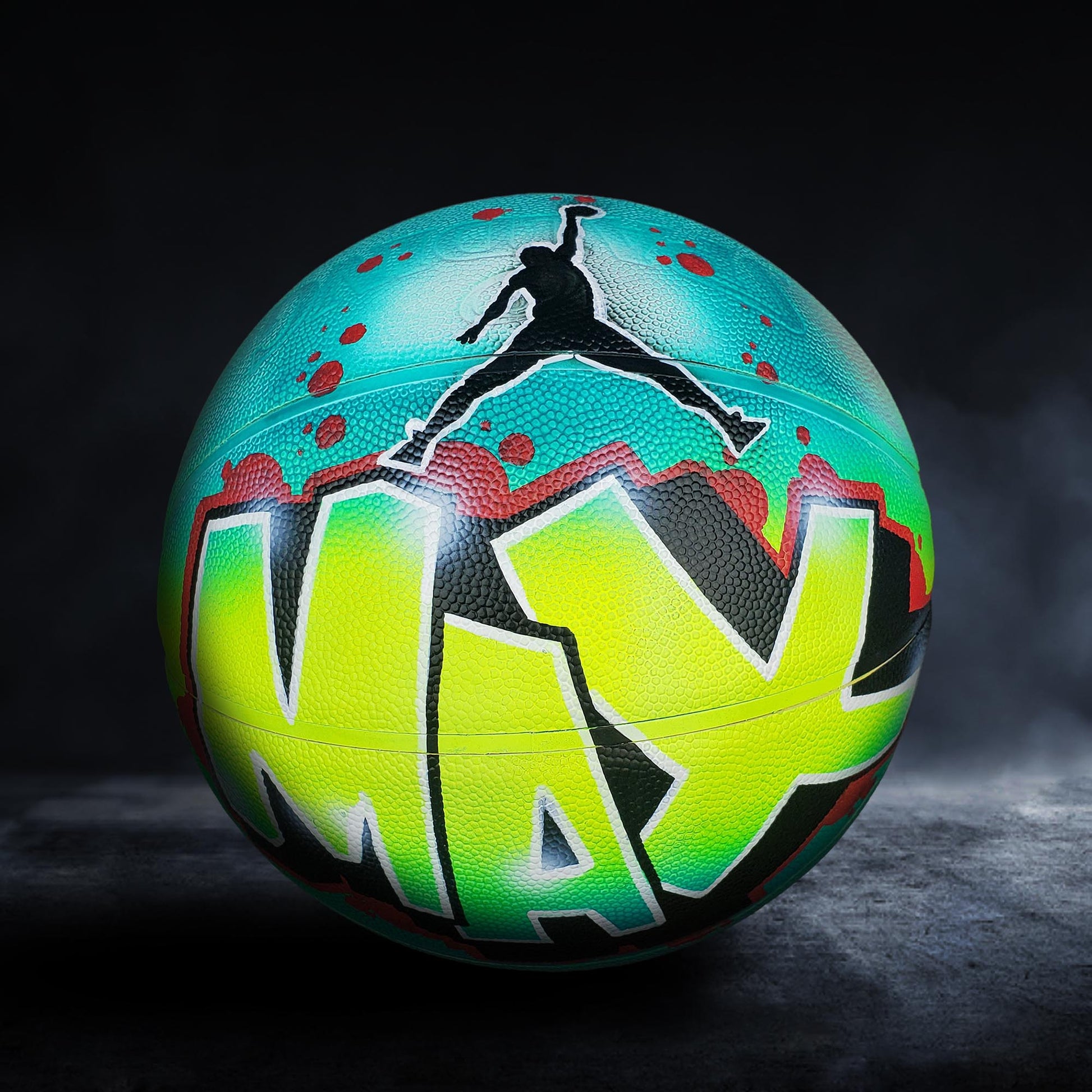 A colorful basketball with the word "MAX" painted on it, featuring a silhouette of a person jumping in the air.