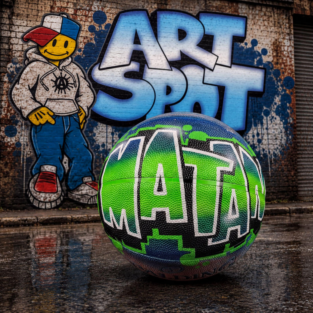 A colorful basketball with the word "MATAM" painted on it, sitting on a wet surface in front of a graffiti-covered wall.