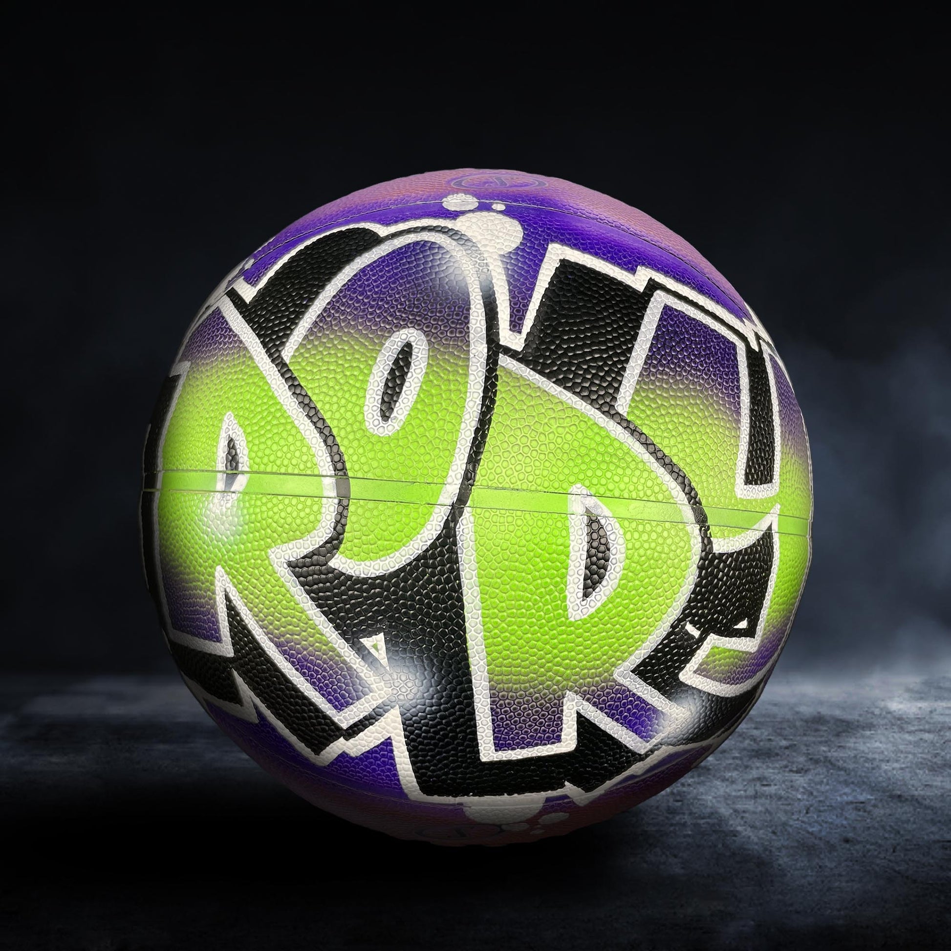 A basketball with the word "POP" painted on it in a colorful, graffiti-style design.