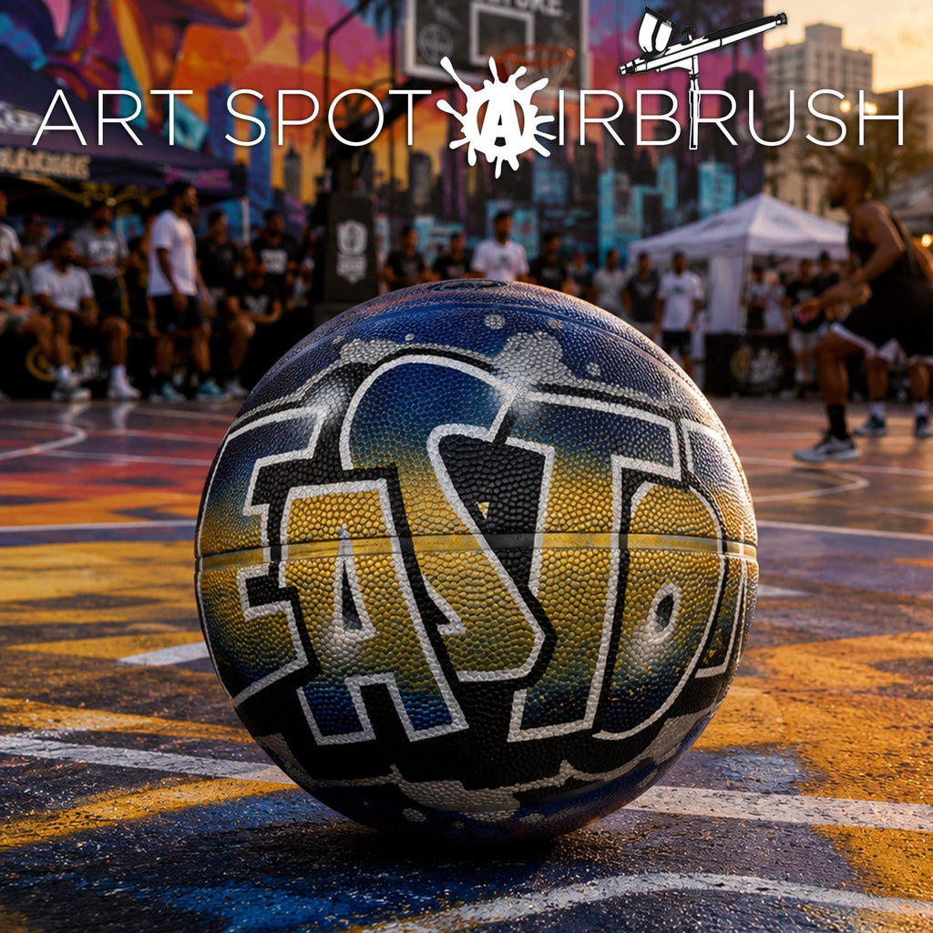 a basketball court with a basketball with graffiti on it, surrounded by a crowd of people.