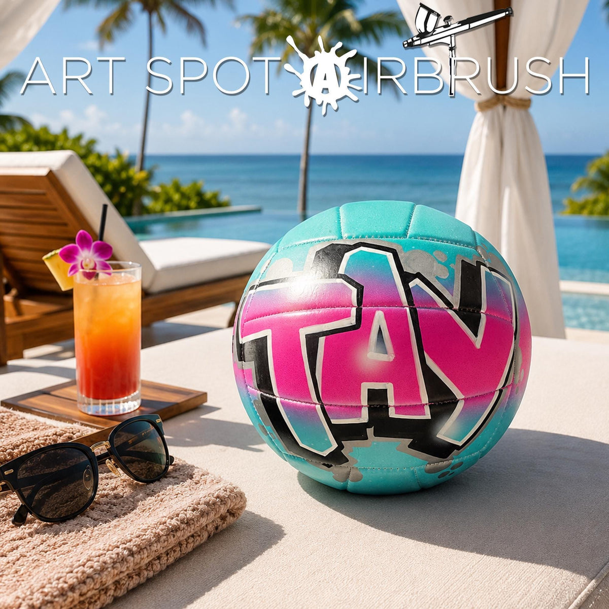a beach scene with a colorful custom volleyball personalized with a name, sunglasses, a drink, and a towel, all set against a backdrop of palm trees and the ocean.