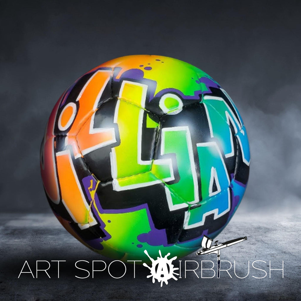 A colorful, graffiti-style soccer ball with the text "ART SPOT AIRBRUSH" written on it.
