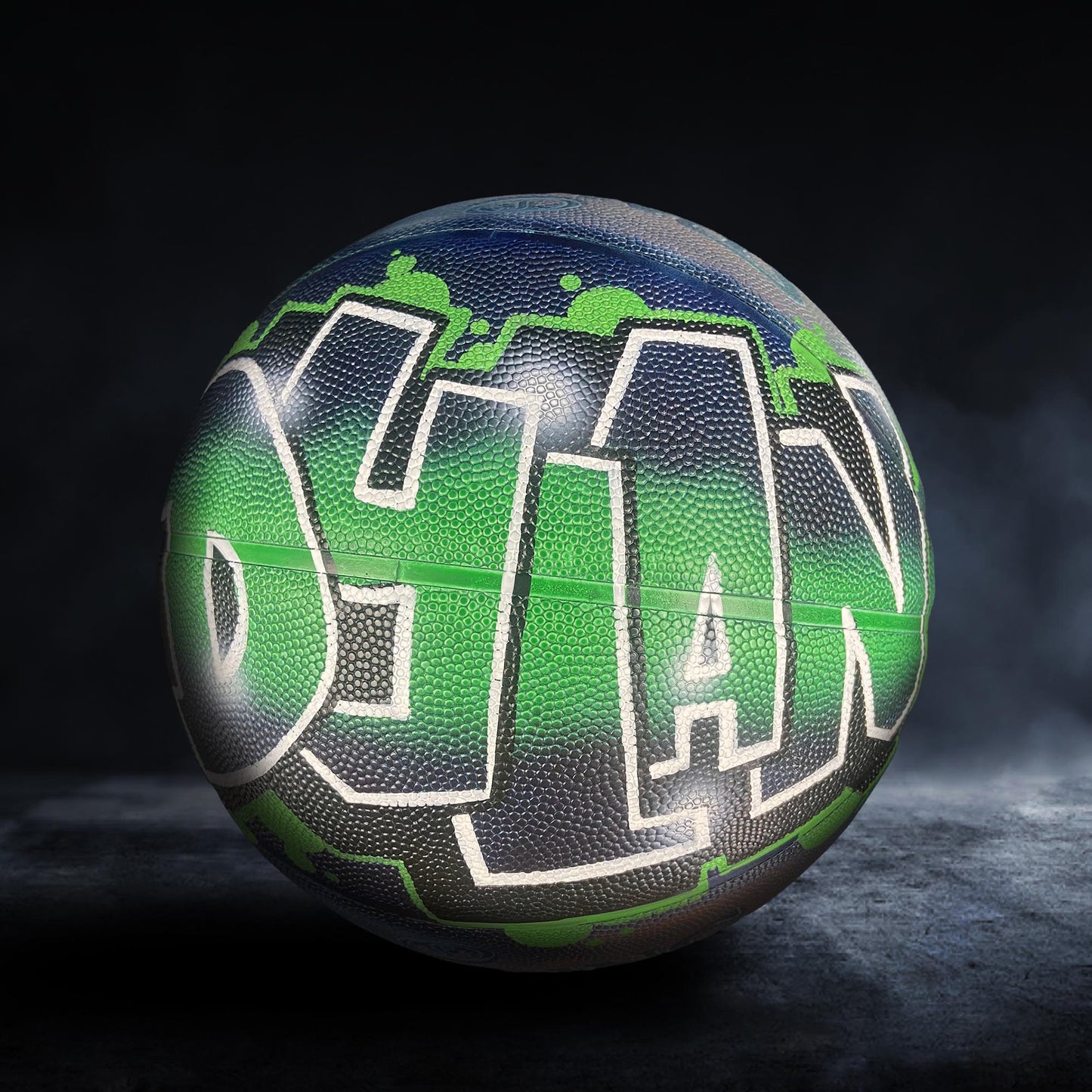 A basketball with the word "YAN" painted on it in a stylized, graffiti-like design.