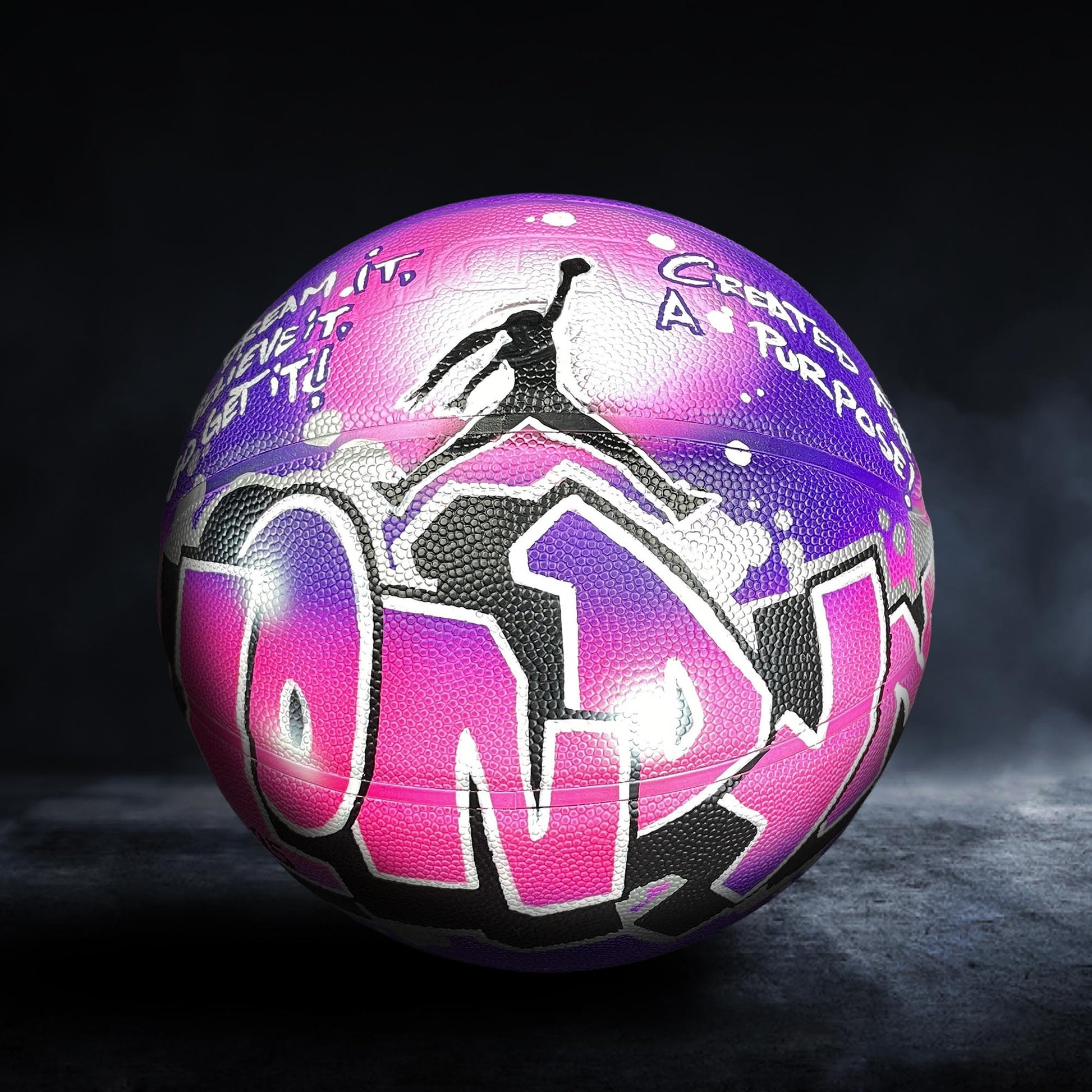 A basketball with a colorful, graffiti-style design on it, featuring the word "ONLY" prominently displayed.