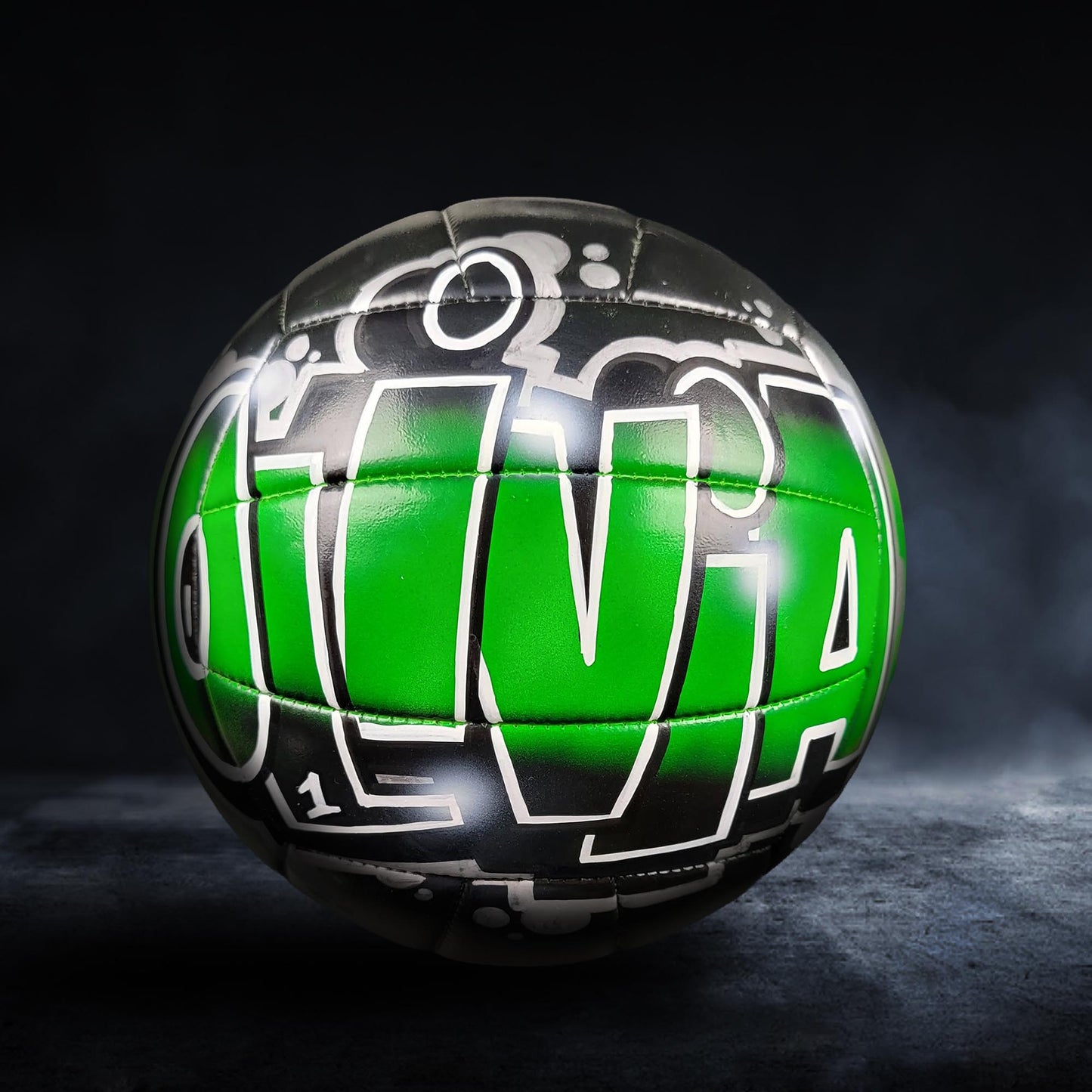 A green and black soccer ball with the word "Olivia" written on it.
