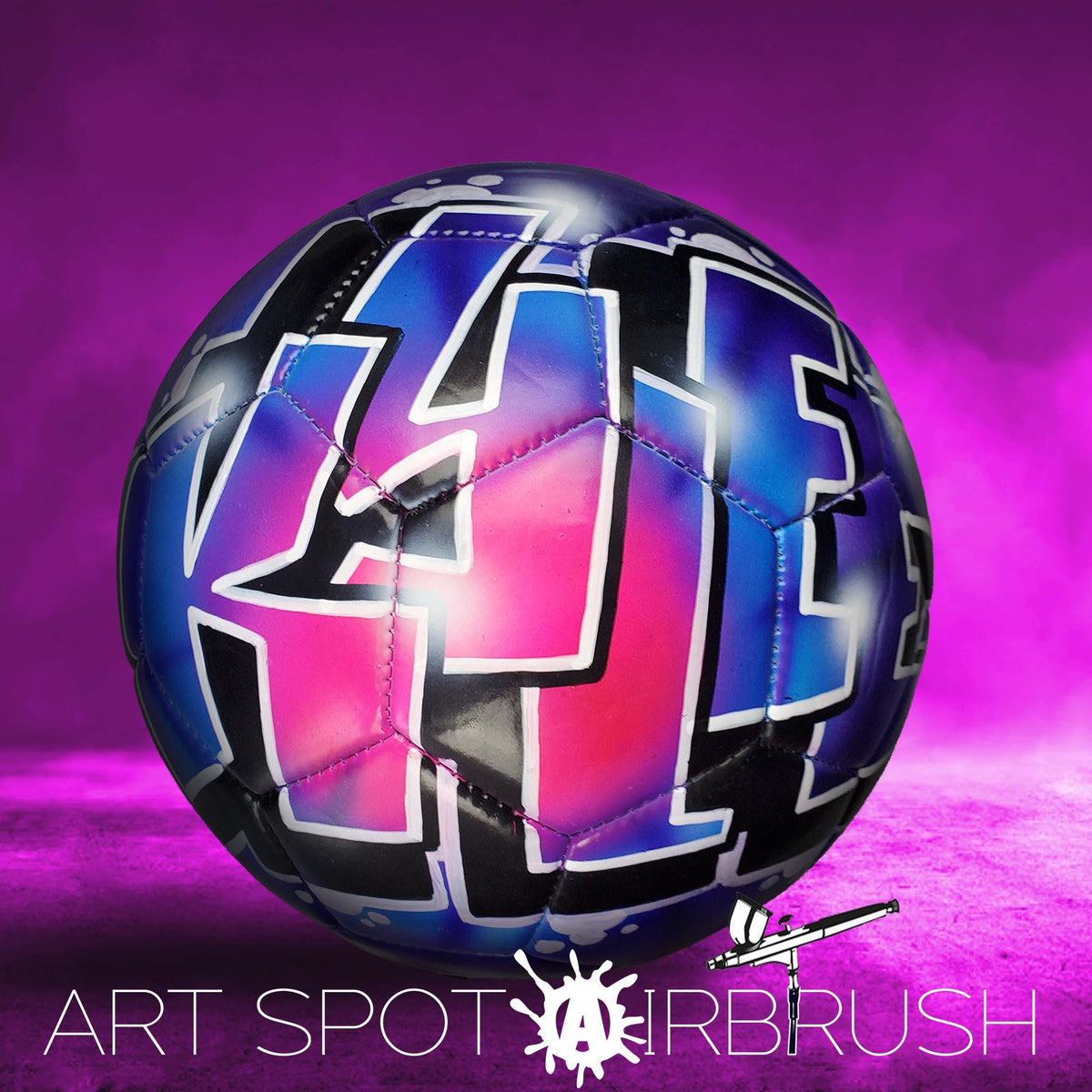 A colorful soccer ball with graffiti-style lettering on it, set against a purple background.