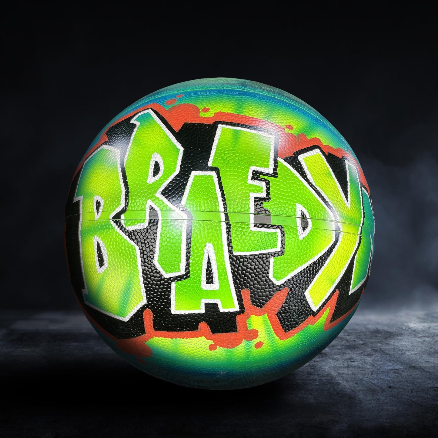 A colorful basketball with the word "BRAEDY" painted on it in a graffiti-style design.