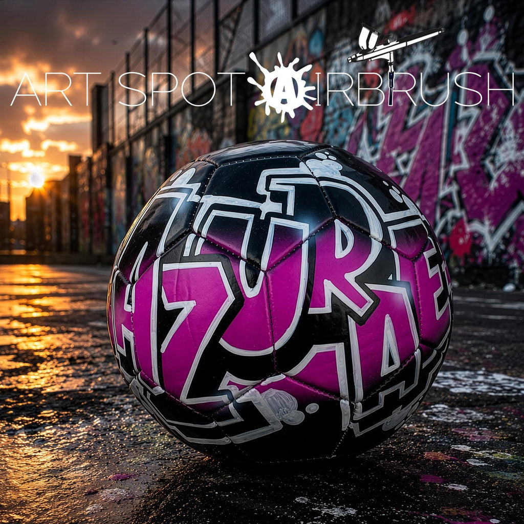 a soccer ball with graffiti on it, placed on a surface with a colorful graffiti wall in the background.