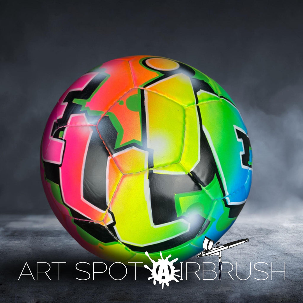 A colorful, graffiti-style soccer ball with a vibrant, abstract design is displayed against a dark background.