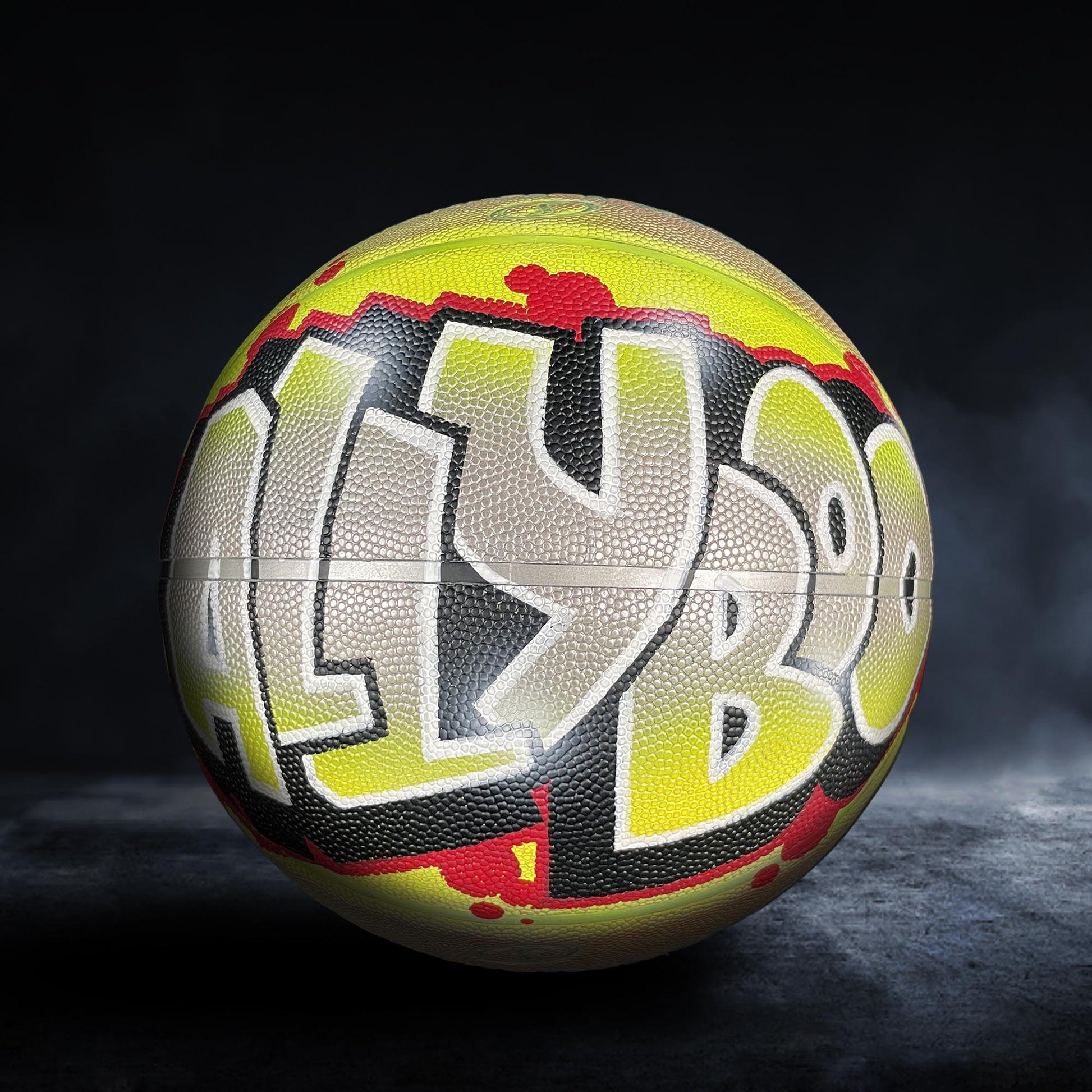A basketball with the word "ALLYBOO" painted on it in a stylized, graffiti-like design.