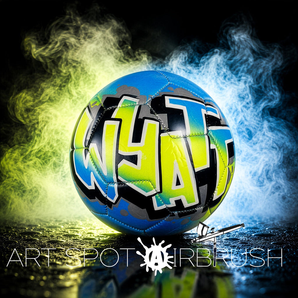 A colorful soccer ball with graffiti-style text on it, surrounded by smoke and a dark background.