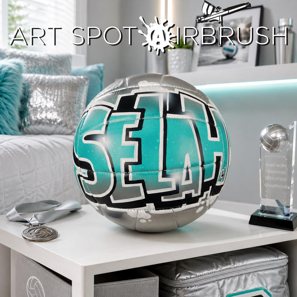 a custom volleyball personalized with the name "SELAH" written on it, placed on a white table. There is also a trophy and some decorative items in the background.