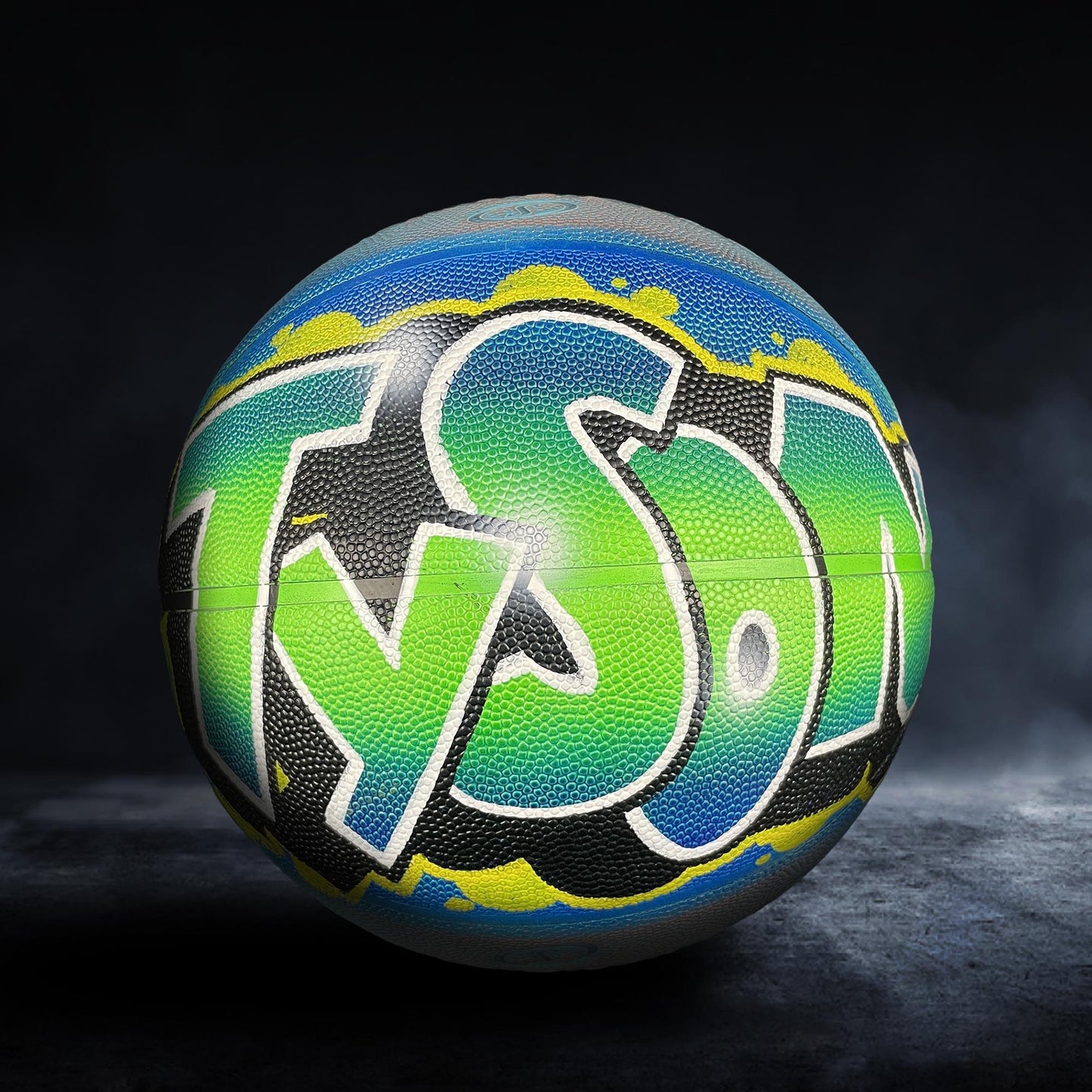 A colorful basketball with the word "TYSON" painted on it, set against a dark background.