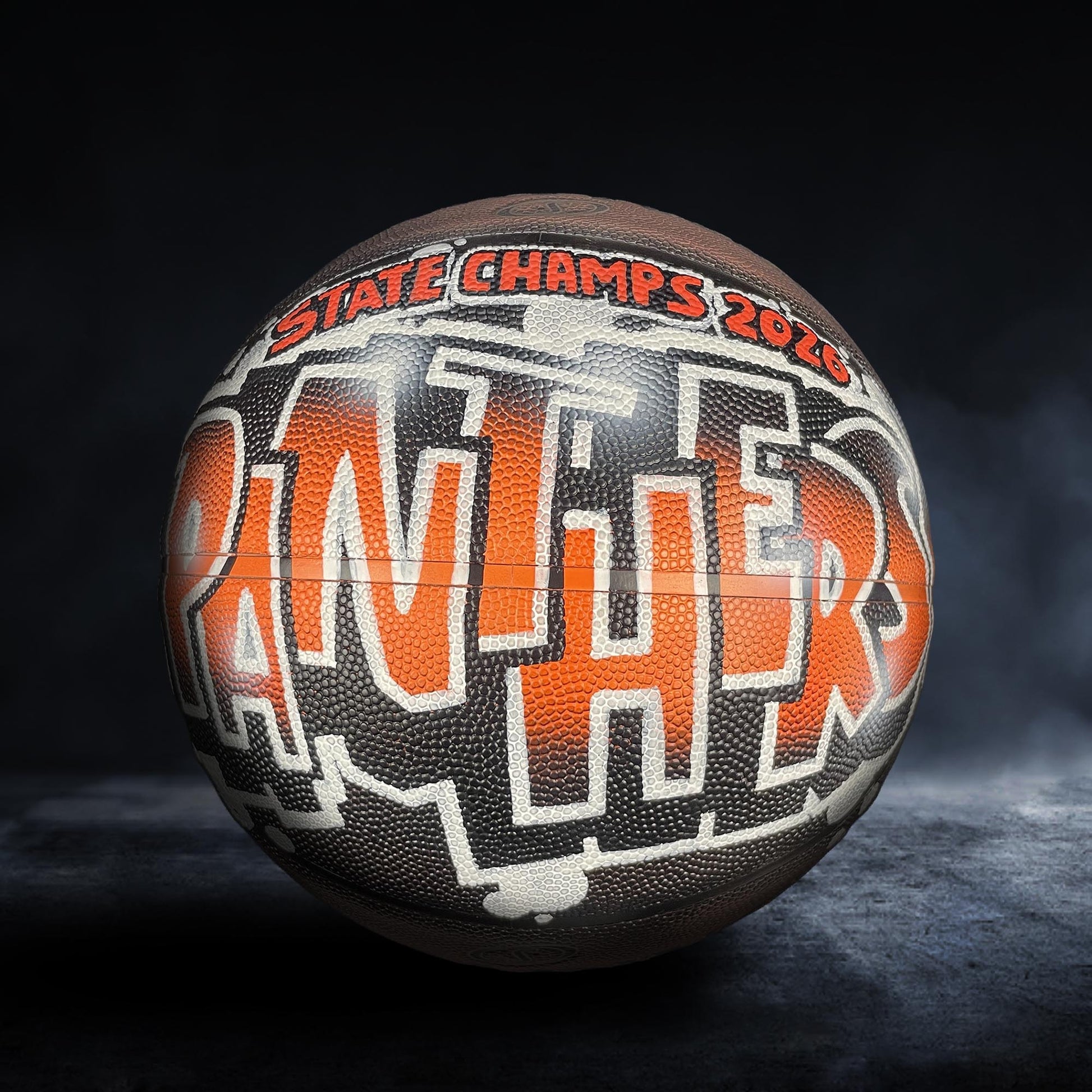 A basketball with the word "Panthers" written on it, indicating a sports achievement or victory.