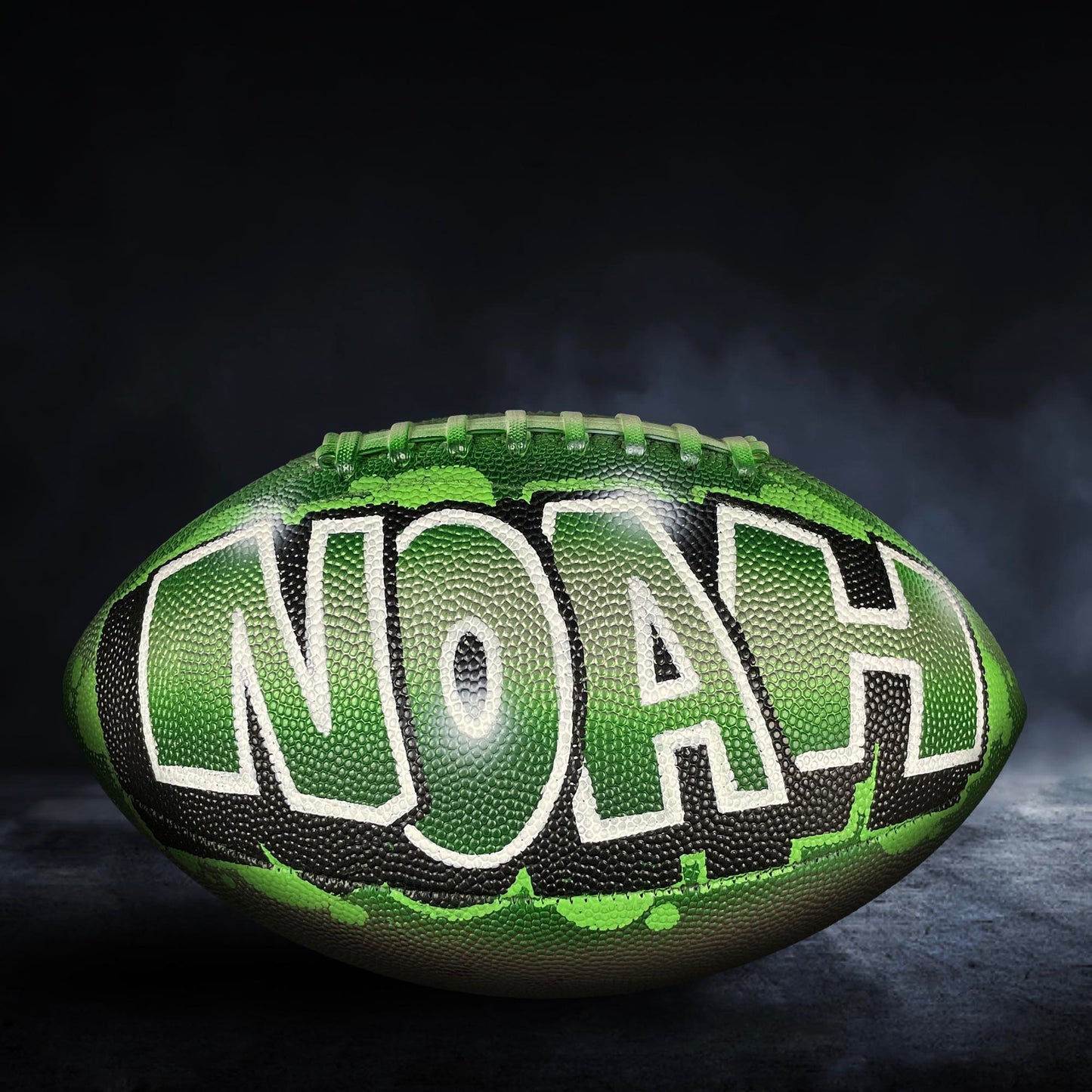 A green and black football with the word "Noah" written on it.