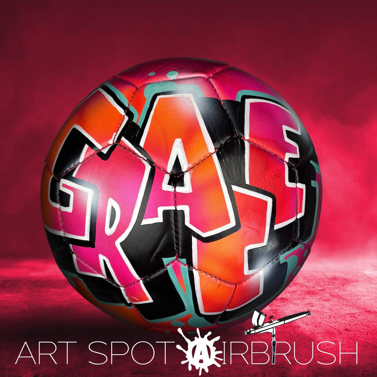 A colorful soccer ball with graffiti-style lettering on it, set against a red background.
