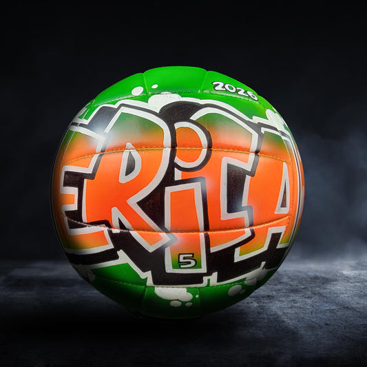 A green and orange sports ball with the text "ERICA" printed on it, against a dark background.
