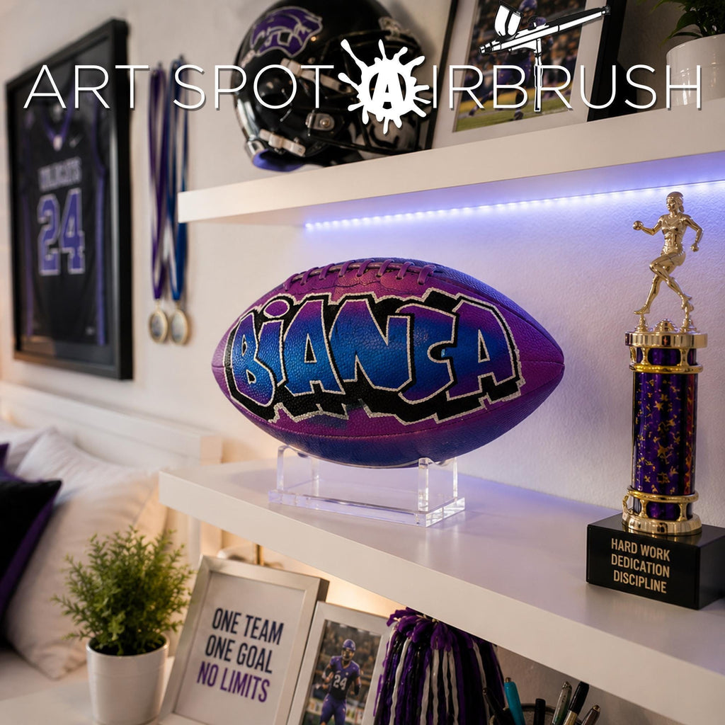 a sports-themed room with various sports memorabilia and awards displayed on shelves beside a custom football personalized with the name BIANCA